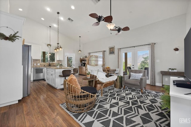 living room with high vaulted ceiling, french doors, sink, ceiling fan, and dark hardwood / wood-style flooring