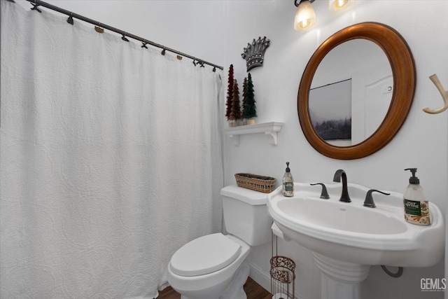 bathroom featuring sink and toilet