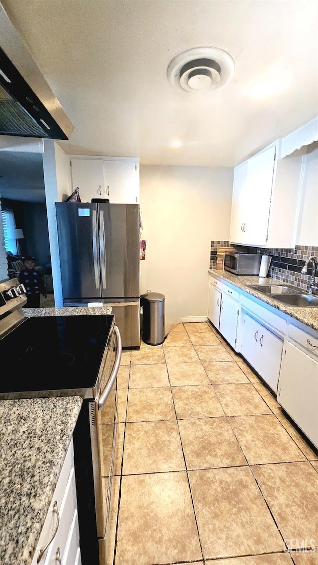 kitchen featuring stainless steel appliances, ventilation hood, sink, and white cabinets