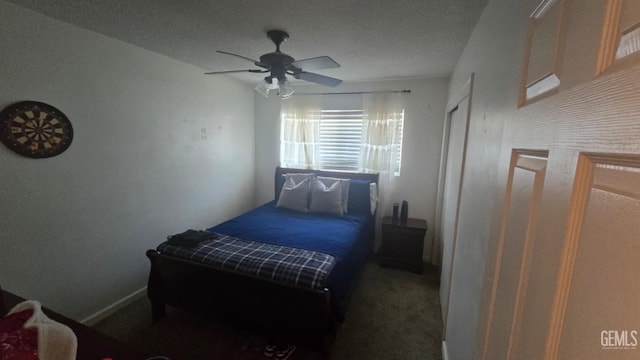 carpeted bedroom featuring ceiling fan and a textured ceiling