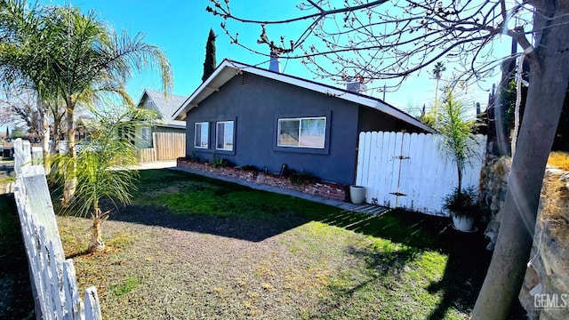 view of home's exterior with a lawn