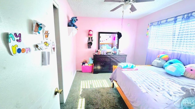 carpeted bedroom featuring ceiling fan and a textured ceiling