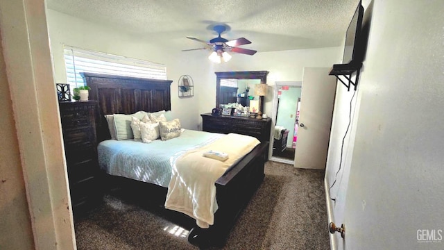 carpeted bedroom featuring ceiling fan and a textured ceiling