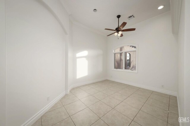 tiled empty room featuring ceiling fan and crown molding