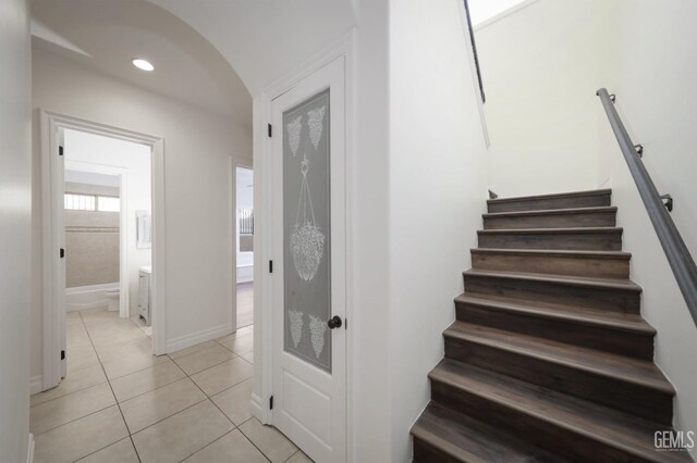 stairway featuring tile patterned flooring