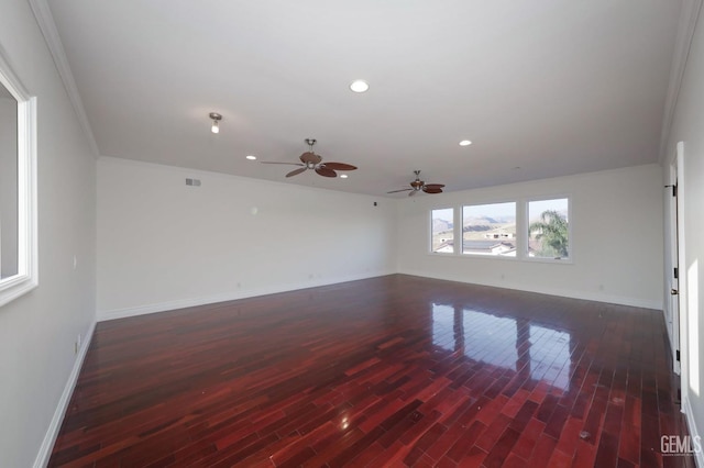 unfurnished room with ceiling fan, crown molding, and dark wood-type flooring