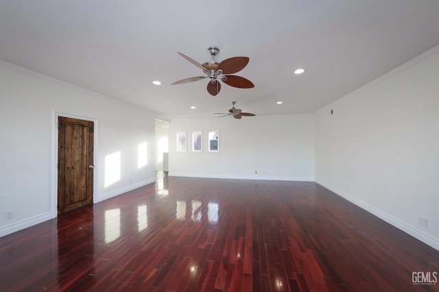 empty room with ceiling fan, dark hardwood / wood-style flooring, and crown molding