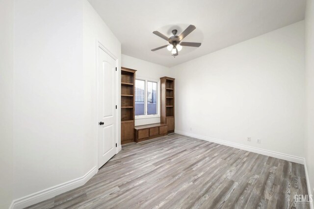 unfurnished bedroom with ceiling fan and light hardwood / wood-style floors