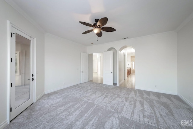 interior space with ceiling fan, light carpet, and ornamental molding