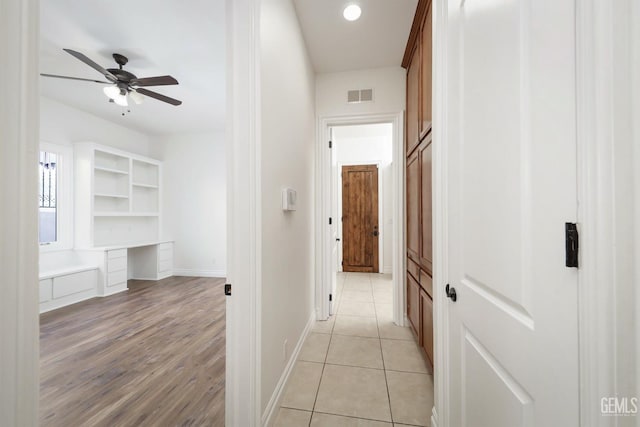 hall with light tile patterned floors