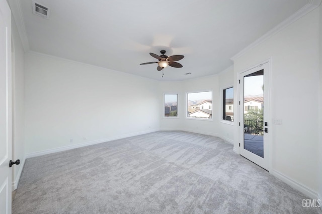 carpeted spare room featuring ceiling fan, french doors, and ornamental molding