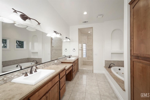 bathroom with plus walk in shower, vanity, and tile patterned floors