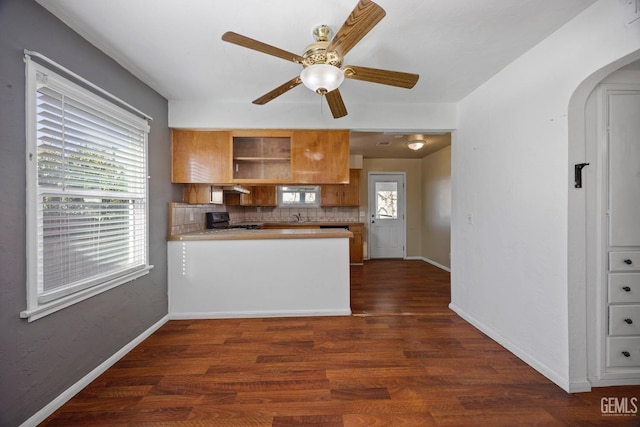 1909 Carrere St, Bakersfield, CA 93308 - kitchen featuring black gas stove, a peninsula, a ceiling fan, arched walkways, and brown cabinetry