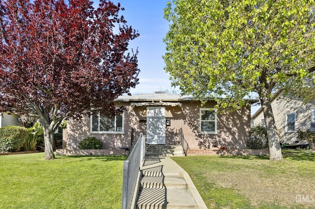1909 Carrere St, Bakersfield, CA 93308 - view of front of home with stucco siding and a front yard