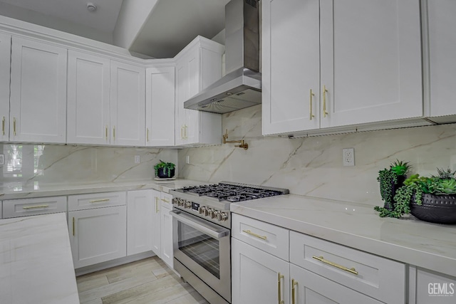 6800 Eagle Cap St, Bakersfield, CA 93313 - kitchen with wall chimney exhaust hood, stainless steel gas stove, white cabinetry, decorative backsplash, and light stone counters