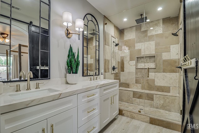 6800 Eagle Cap St, Bakersfield, CA 93313 - full bathroom with a stall shower, double vanity, recessed lighting, wood finished floors, and ceiling fan