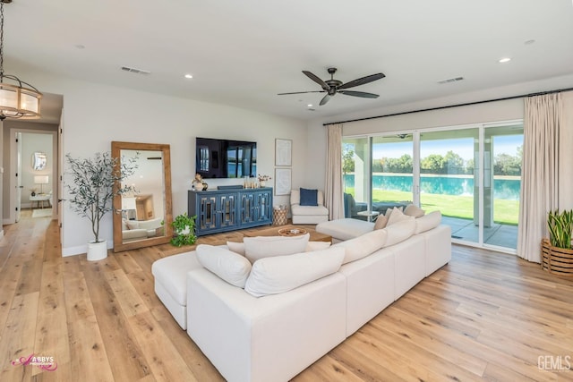 living room with ceiling fan and light wood-type flooring