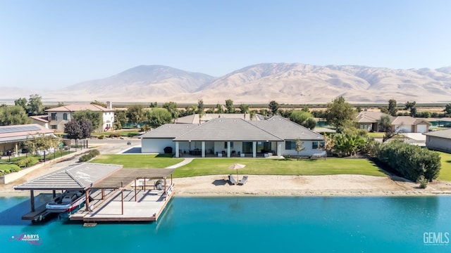 view of swimming pool featuring a yard, a water and mountain view, and a dock