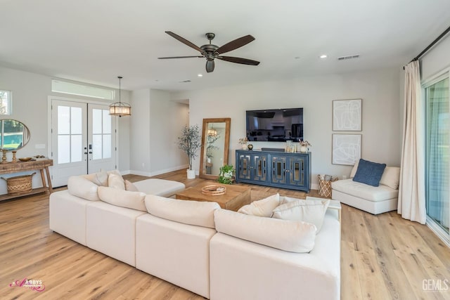 living room with french doors, light hardwood / wood-style flooring, and ceiling fan