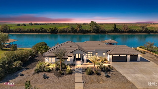 exterior space with a garage and a water view