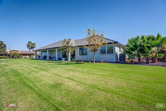 view of front of property featuring a front yard and cooling unit