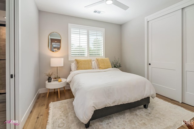 bedroom featuring ceiling fan, a closet, and light hardwood / wood-style flooring