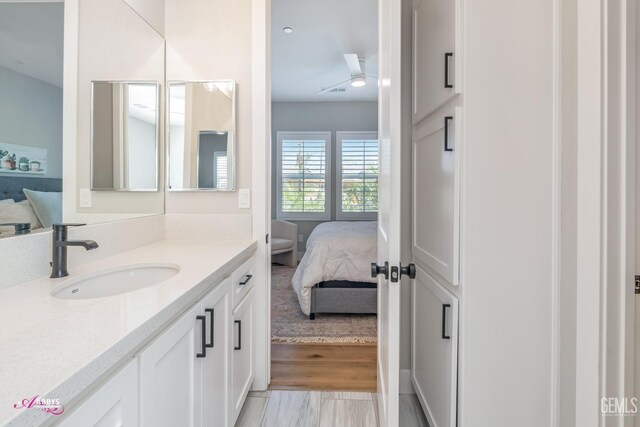 bathroom with ceiling fan and vanity