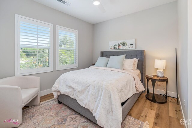 bedroom with ceiling fan and light wood-type flooring