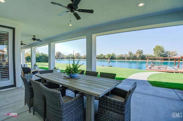 view of patio / terrace featuring a water view and ceiling fan