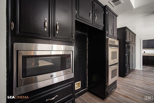 kitchen featuring appliances with stainless steel finishes and light hardwood / wood-style floors