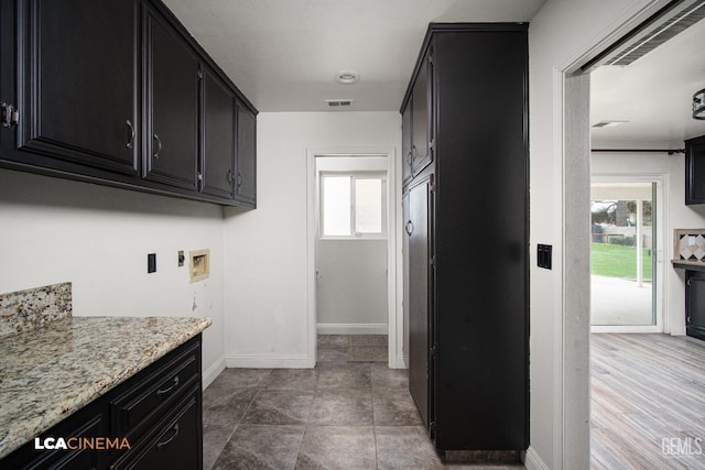 laundry area with washer hookup, plenty of natural light, and cabinets