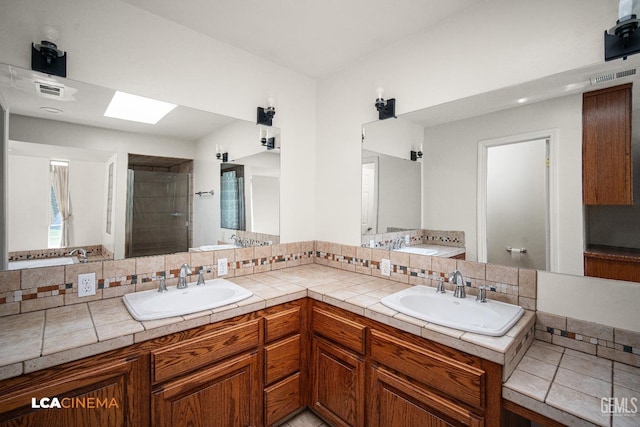 bathroom featuring vanity, a shower, backsplash, and a skylight