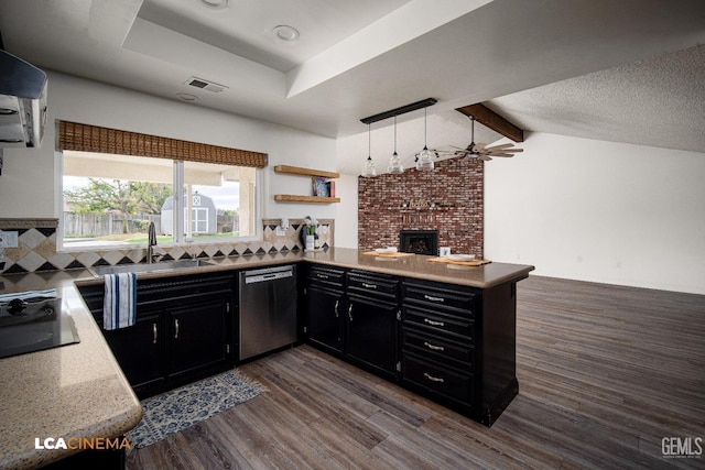 kitchen featuring black gas cooktop, dark hardwood / wood-style flooring, decorative backsplash, stainless steel dishwasher, and kitchen peninsula