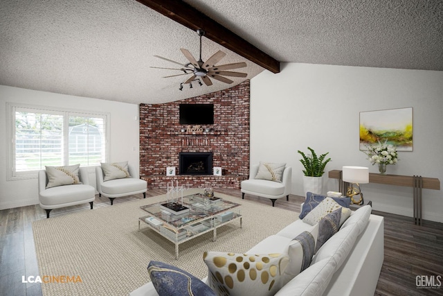 living room with lofted ceiling with beams, a brick fireplace, a textured ceiling, dark hardwood / wood-style flooring, and ceiling fan