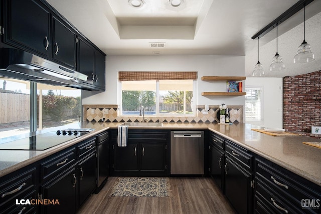 kitchen featuring decorative light fixtures, sink, black electric stovetop, stainless steel dishwasher, and a raised ceiling