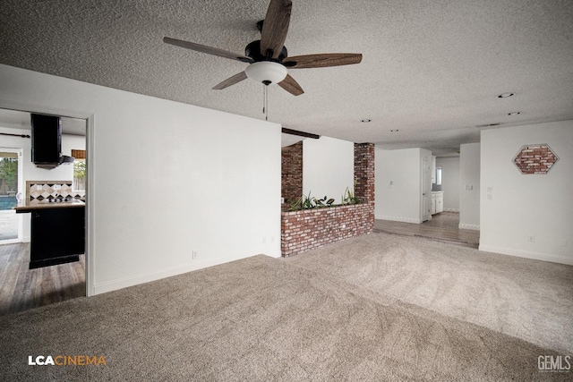 unfurnished living room with ceiling fan, carpet, and a textured ceiling