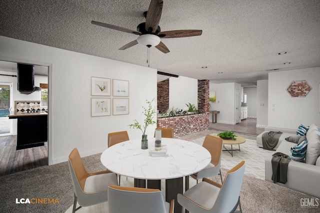 dining room featuring ceiling fan and a textured ceiling