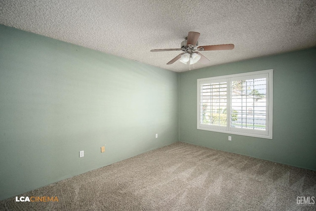 spare room featuring ceiling fan, carpet, and a textured ceiling