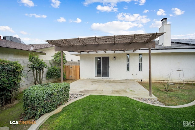 rear view of house featuring a pergola, a patio, and a lawn