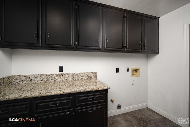 laundry area with cabinets, hookup for a gas dryer, hookup for a washing machine, and dark tile patterned floors