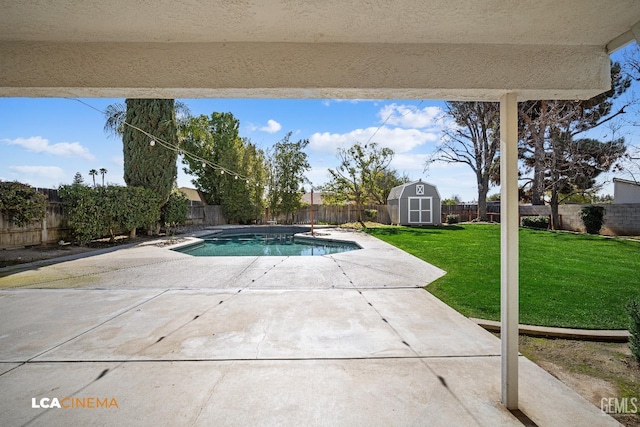 view of swimming pool with a storage shed, a patio, and a lawn