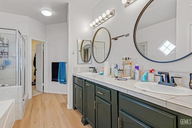 11602 Marazion Hill Ct, Bakersfield, CA 93311 - full bathroom featuring double vanity, a sink, a stall shower, and wood finished floors