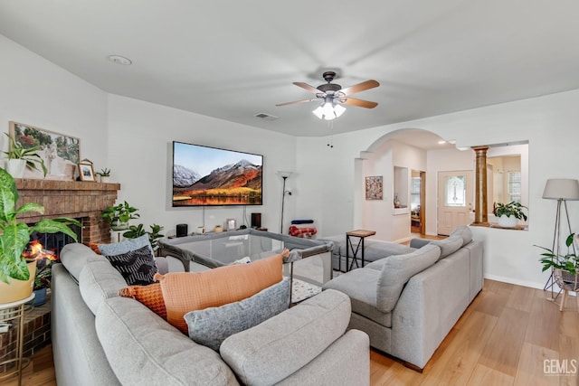11602 Marazion Hill Ct, Bakersfield, CA 93311 - living room with decorative columns, light wood-style floors, a ceiling fan, visible vents, and arched walkways