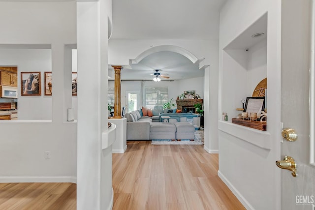 11602 Marazion Hill Ct, Bakersfield, CA 93311 - hall with arched walkways, baseboards, light wood finished floors, and ornate columns