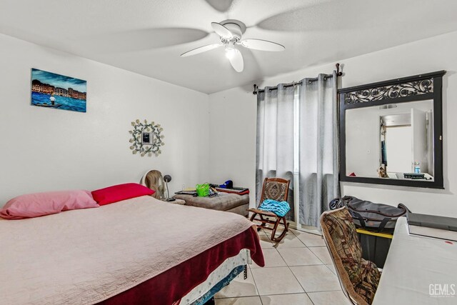 tiled bedroom with ceiling fan