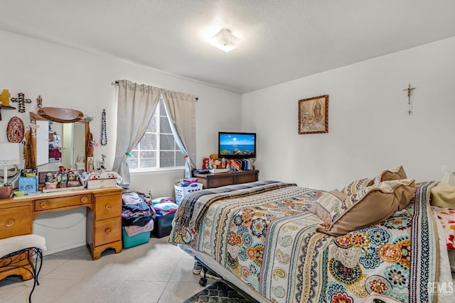 tiled bedroom featuring a textured ceiling