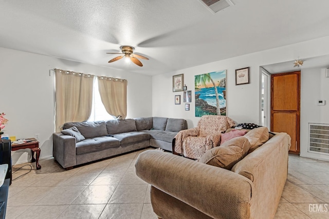 tiled living room featuring a textured ceiling, heating unit, and ceiling fan