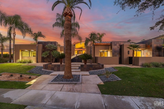 view of front of property with a yard