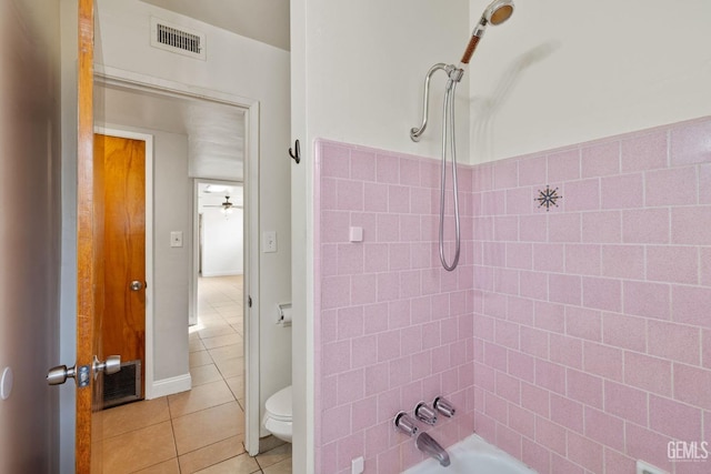 bathroom with bathing tub / shower combination, tile patterned floors, ceiling fan, and toilet