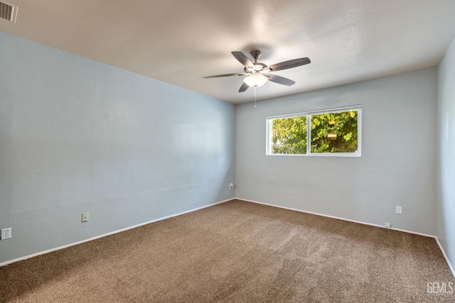 empty room with ceiling fan and carpet